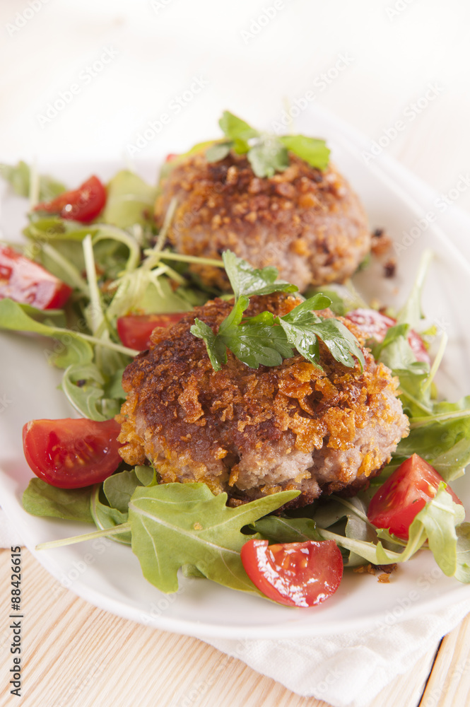 tasty chops with arugula and tomato 