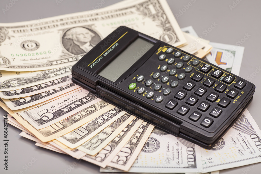 calculator on dollars isolated on gray background calculator on dollars isolated on gray background