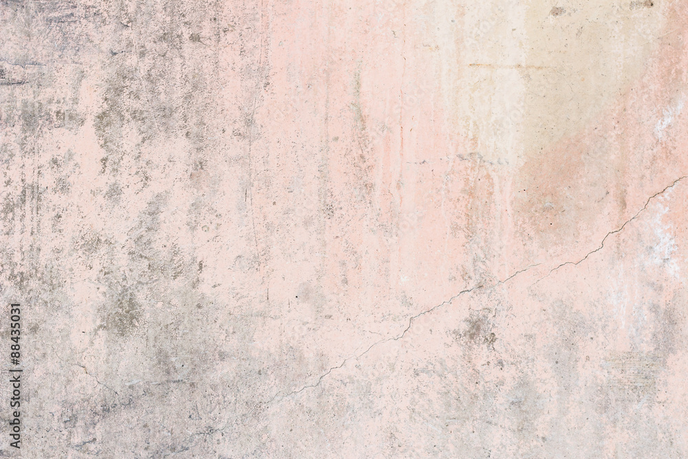 Worn pale pink concrete wall texture background with paint partly faded.