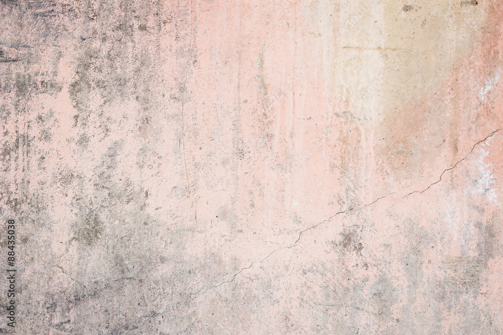 Worn pale pink concrete wall texture background with a bit of vignetting, paint partly faded.