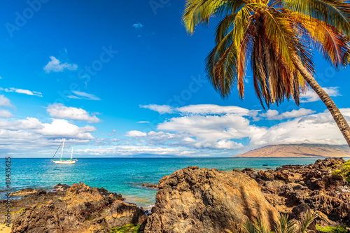 A sailboat moored off the coast of Kamaole Beach in Kihei on Maui, Hawaii
