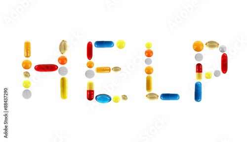 The word Help made with pills isolated on white