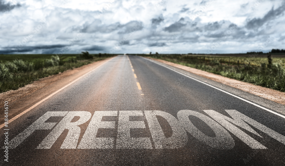 Freedom written on rural road