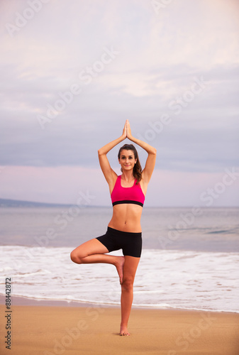 Yoga Woman on the Beach At Sunset