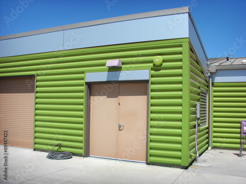 modern green metal building with doors
