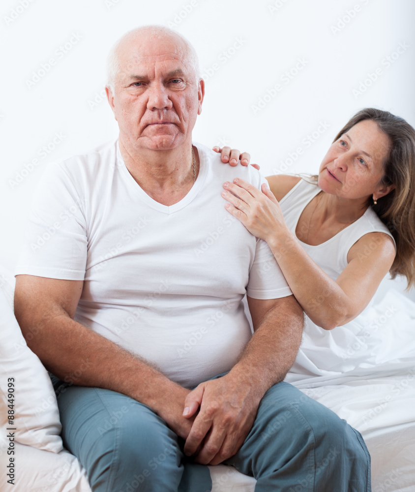 man sitting in bed and quarrelling with wife. man sitting in bed and quarrelling with wife.