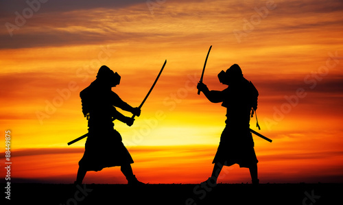 Silhouette of two samurais in duel. 