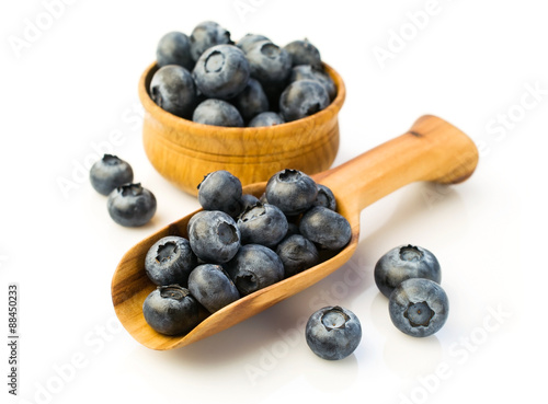 Ripe blueberries in a wooden scoop