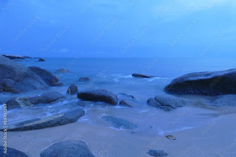view of the beach, stone and sea at night view of the beach, stone and sea at night