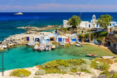 Scenic Mandrakia village (traditional Greek village by the sea) with sirmate - traditional fishermen's houses, Milos island, Cyclades, Greece. photo