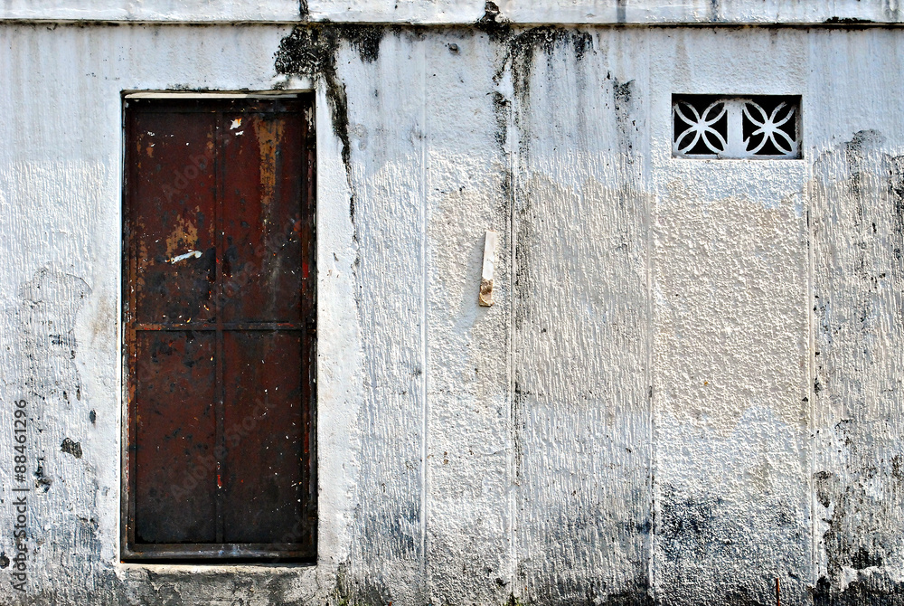 Old Brown Metal Door on a White Gate