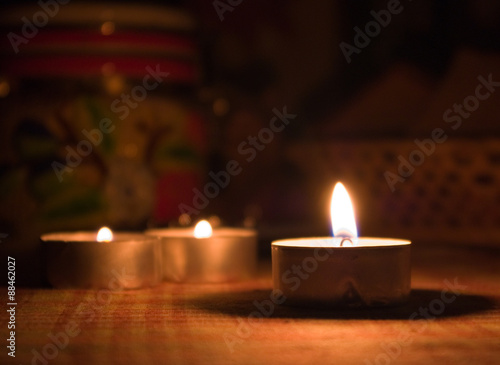 Three candles on a table in a dark