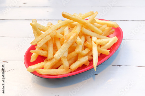 French fries in a red plate.