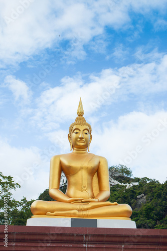 This is Gold Buddha statue in the asian temple  With sky background.