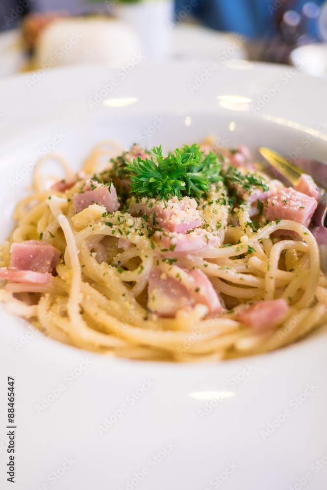 Spaghetti carbonara (with ham) on white plate Spaghetti carbonara (with ham) on white plate