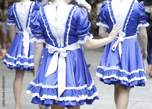 Back view of three women wearing one of the folk costume of United States