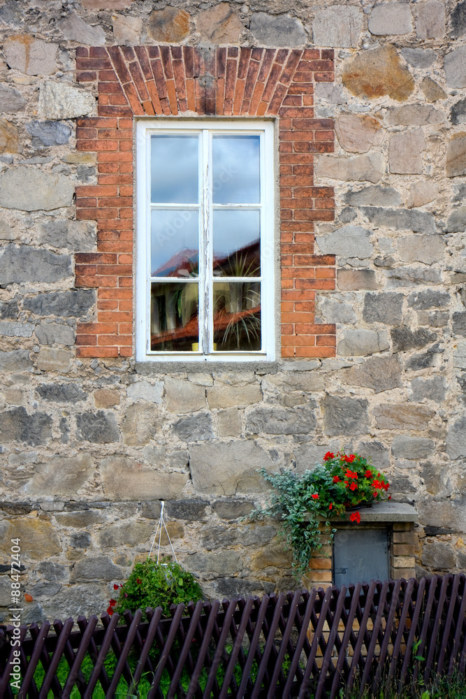window on rustic stone wall