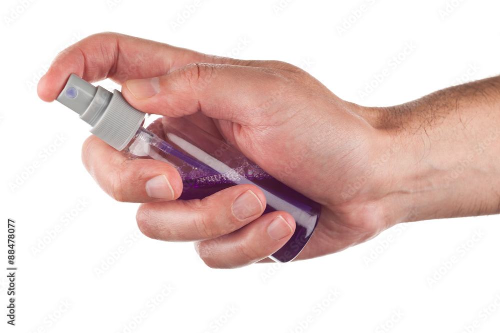 Hand holding a spray bottle Hand holding a spray bottle