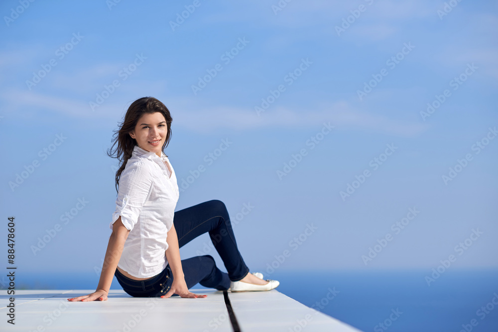 relaxed woman in front of luxury modern home