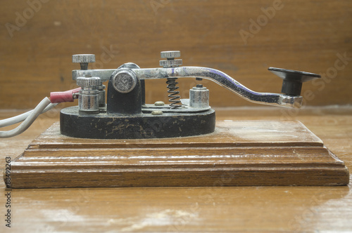 old morse key telegraph on wood table photo