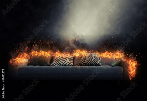 Sofa engulfed in burning flames photo