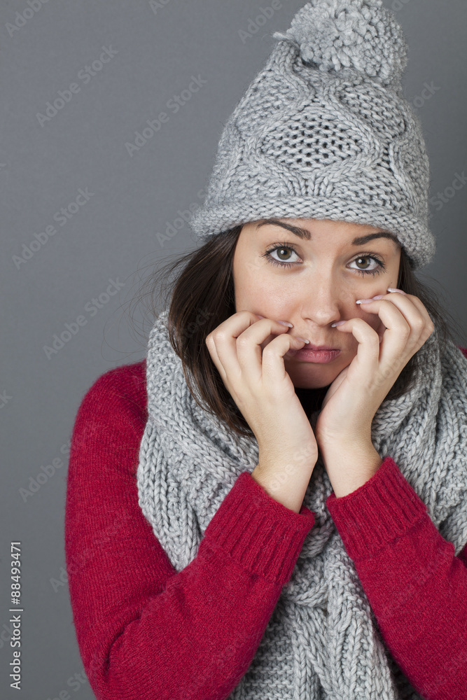 disappointment concept - portrait of sad 20s woman with winter grey winter hat and scarf expressing disappointment with hands and expressive face,studio shot disappointment concept - portrait of sad 20s woman with winter grey winter hat and scarf expressing disappointment with hands and expressive face,studio shot