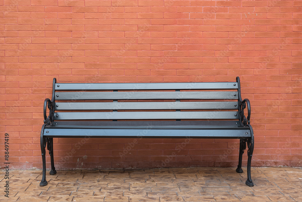 black wooden classic bench with brick wall black wooden classic bench with brick wall