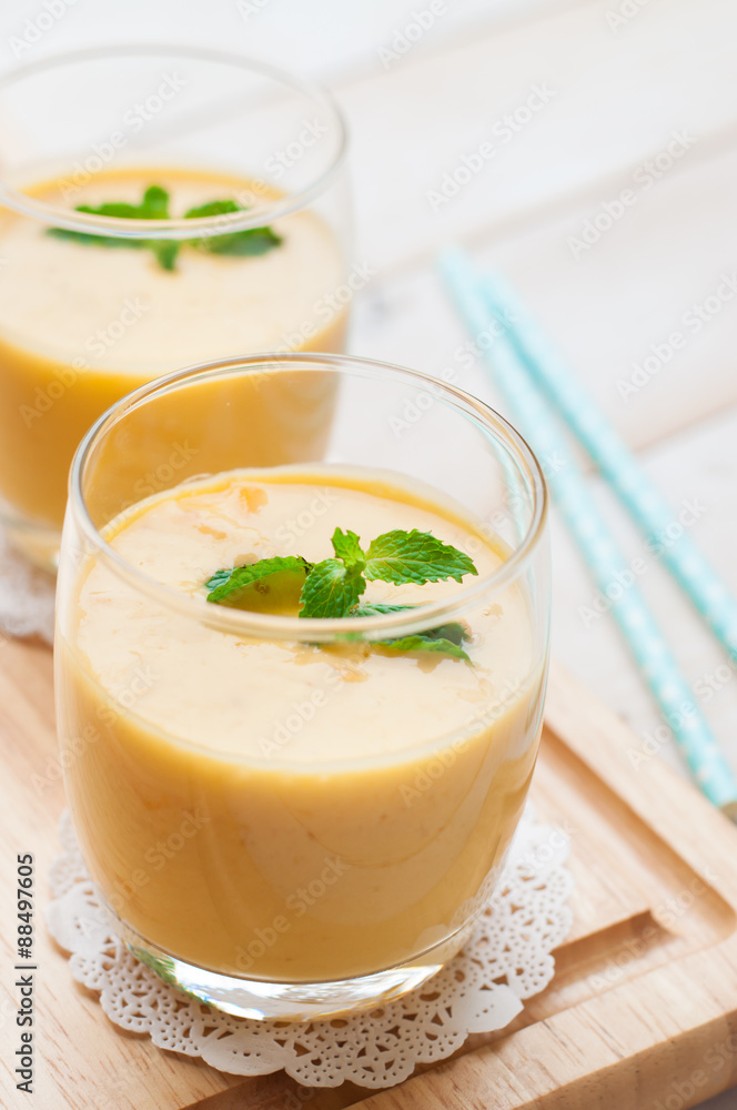 Healthy drink mango smoothies with mint on wooden background Healthy drink mango smoothies with mint on wooden background