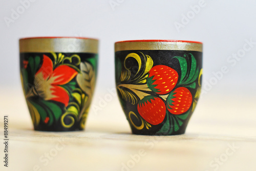 Two Russian traditional wooden cups in the style of Khokhloma