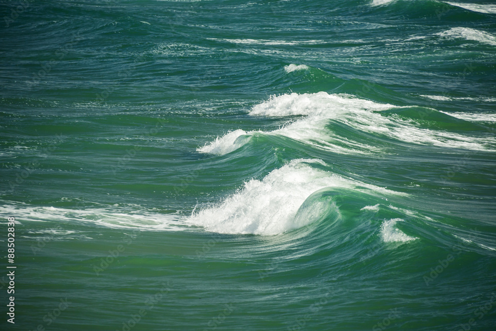 Fototapeta premium Sea waves splashing through the summer day