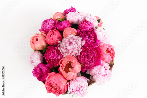 Rich bunch of peonies and tea roses on white background