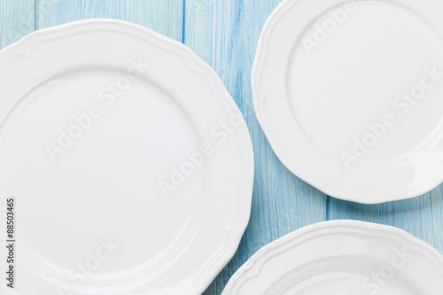 Empty plates over wooden table