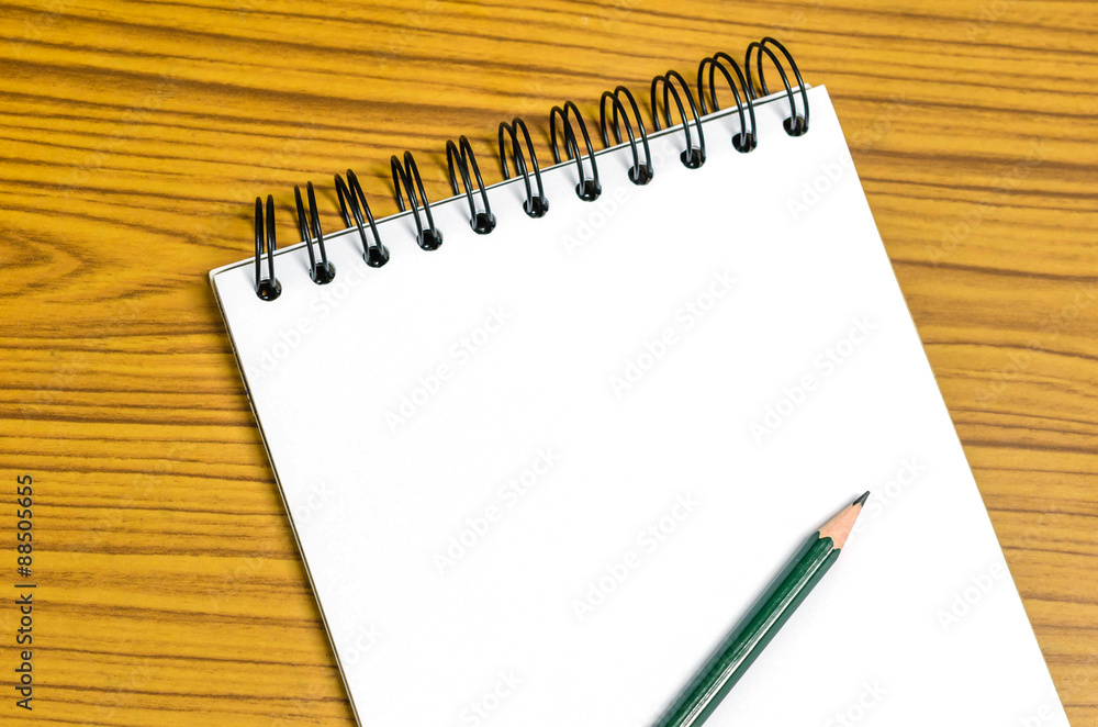 white paper and pencil on the wooden table white paper and pencil on the wooden table