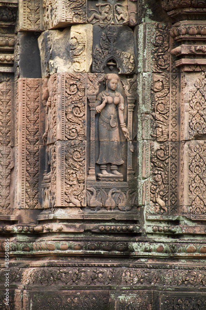 Detail of stone carving decoration in Banteay Srei showing women.near Seim Reap, Cambodia
