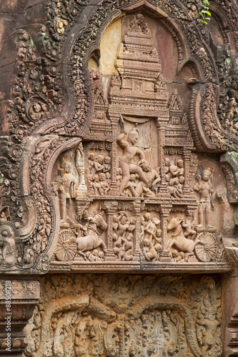 Detail of stone carving decoration in Banteay Srei showing war and battle scenes.near Seim Reap, Cambodia