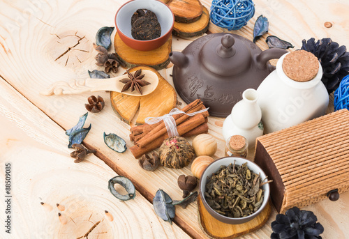 dry tea leaves cinnamon and on wooden background © Natalia Merzlyakova
