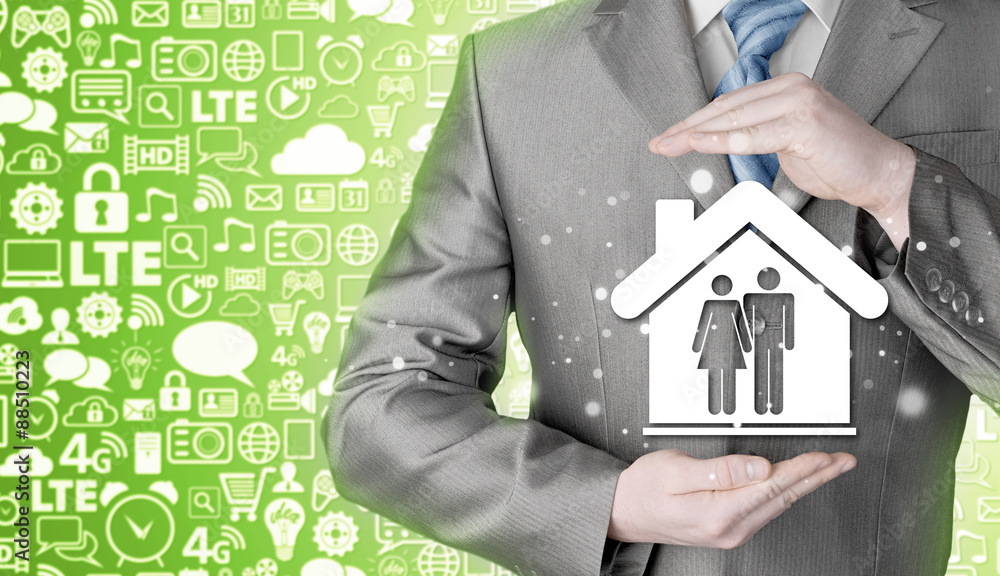 businessman protecting family in home with hands businessman protecting family in home with hands