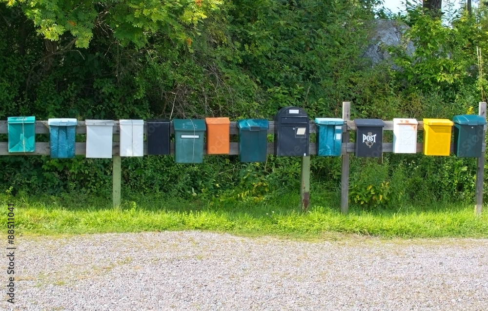 Mailboxes in a row at rural cabin site, Sweden summertime.