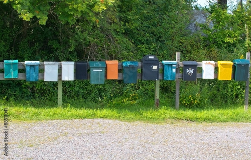 Mailboxes in a row at rural cabin site, Sweden summertime.