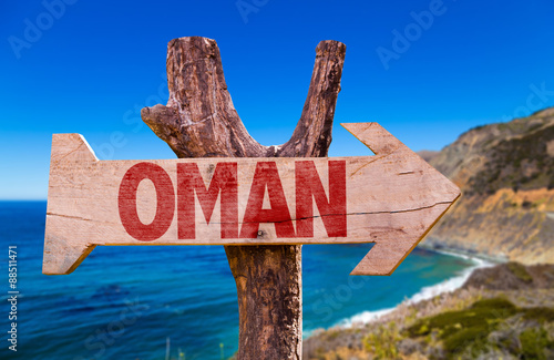 Oman wooden sign with coast background photo