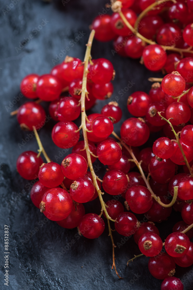 Fresh ripe redcurrant fruit on slate background Fresh ripe redcurrant fruit on slate background