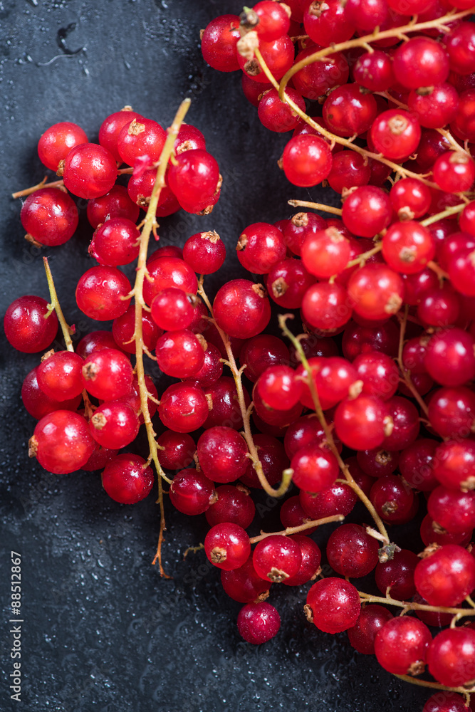 Fresh ripe redcurrant fruit on slate background Fresh ripe redcurrant fruit on slate background