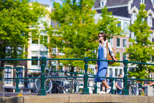 Canvas Print Young caucasian girl enjoy european vacation in Amsterdam