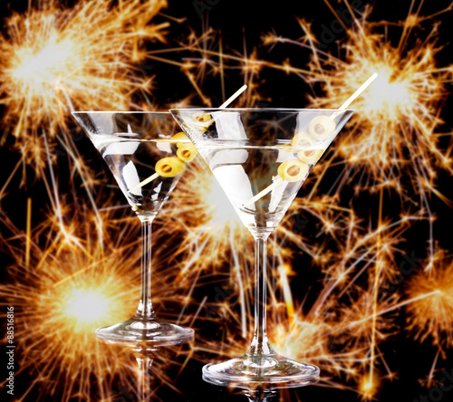 Cocktails in martini glasses on bright sparklers background