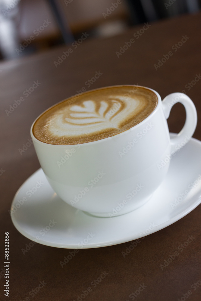 Fototapeta premium Cup of art latte or cappuccino coffee.
