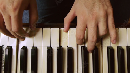 Male piano player hands with dolly slider motion. On a grand piano.