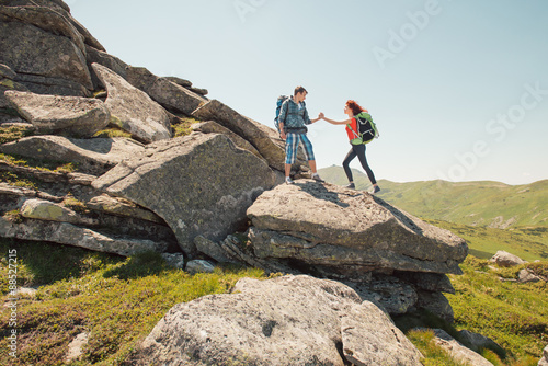 Young couple climbing in the mountains