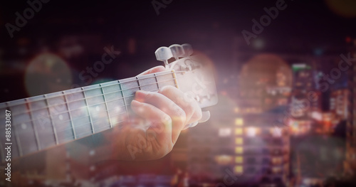 Man playing acoustic guitar with outdoor background