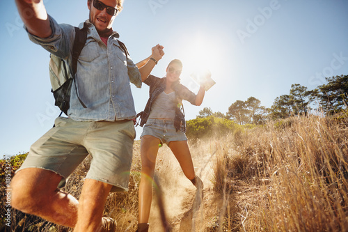 Happy young couple having fun on their hiking trip