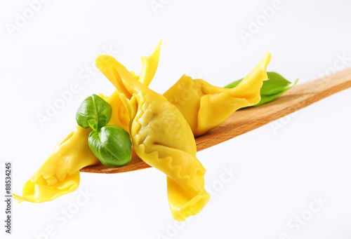 Stuffed pasta on wooden spatula photo